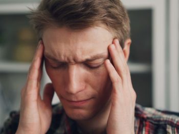 a man holding his hands to his ears
