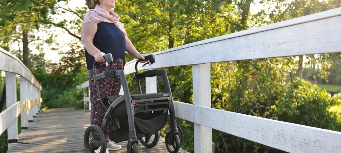 a woman with a stroller on a bridge